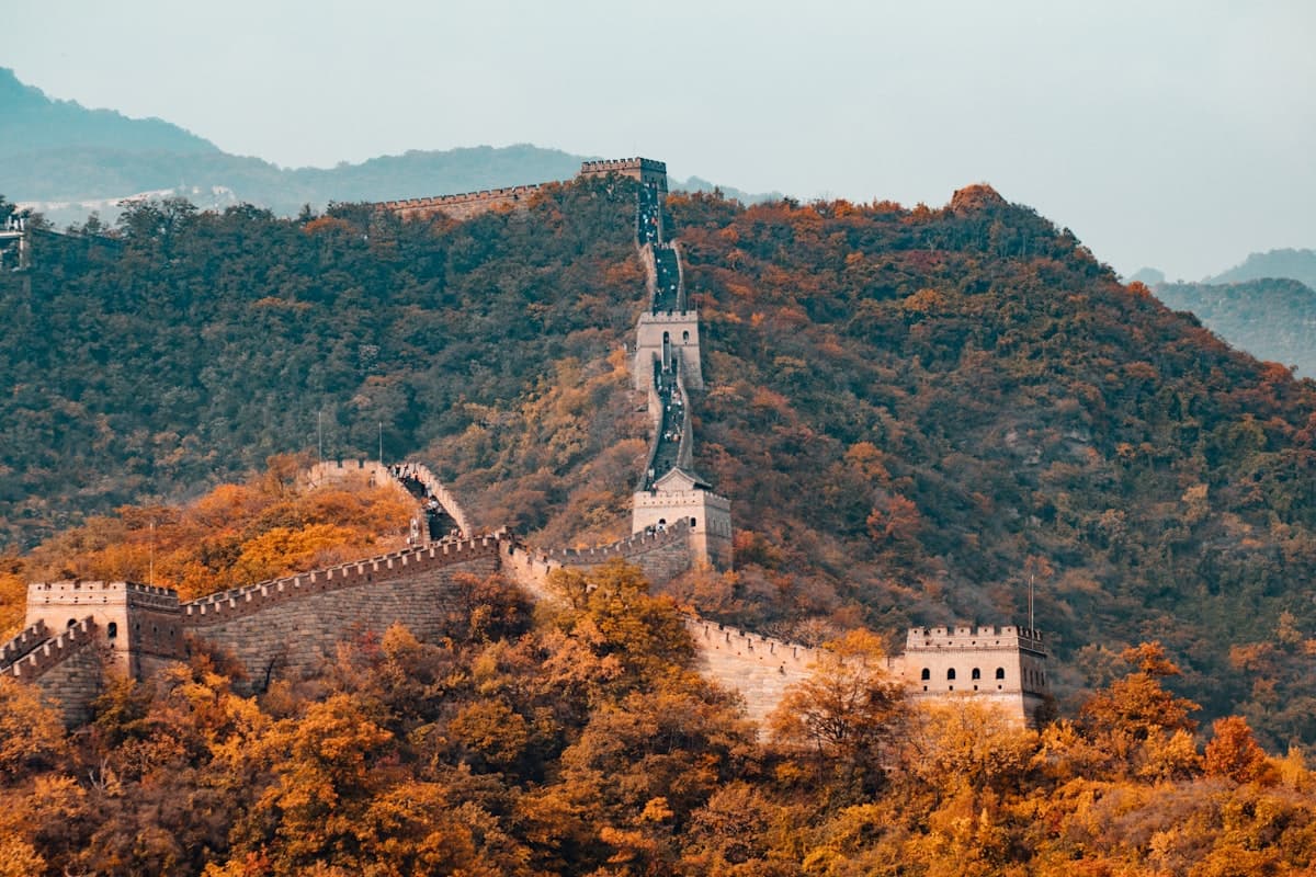 The Great Wall following a forested ridge through autumn colour