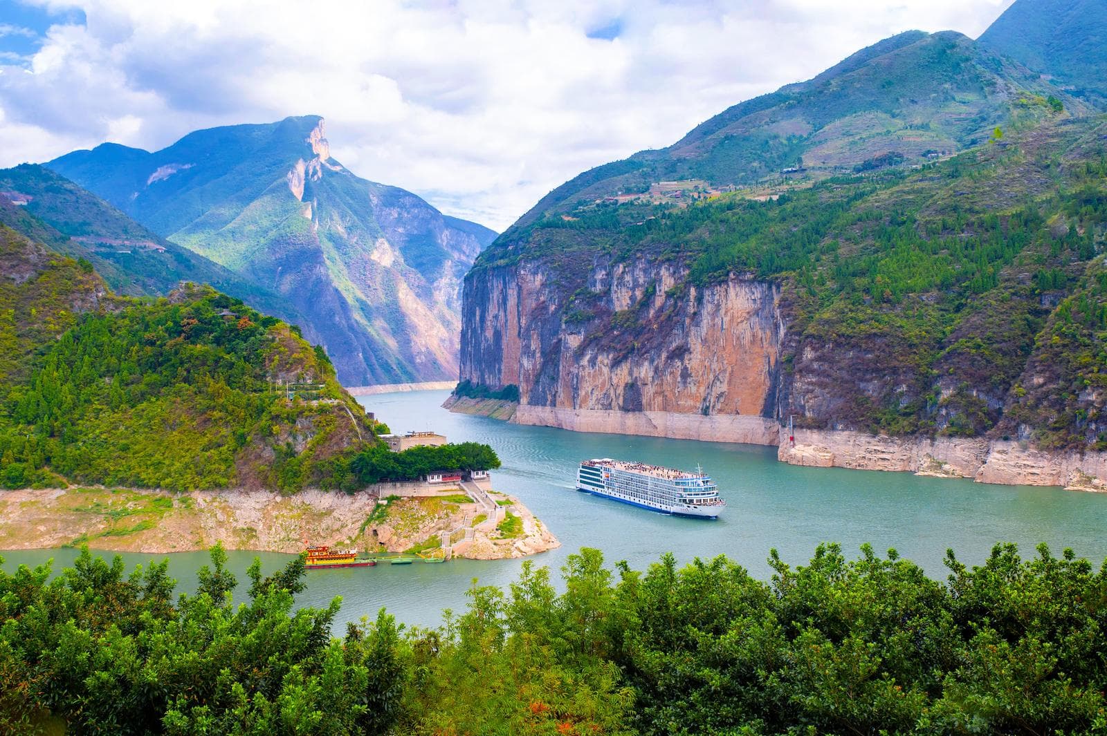 A Century Cruises vessel under way on the Yangtze, gorge cliffs rising on both sides
