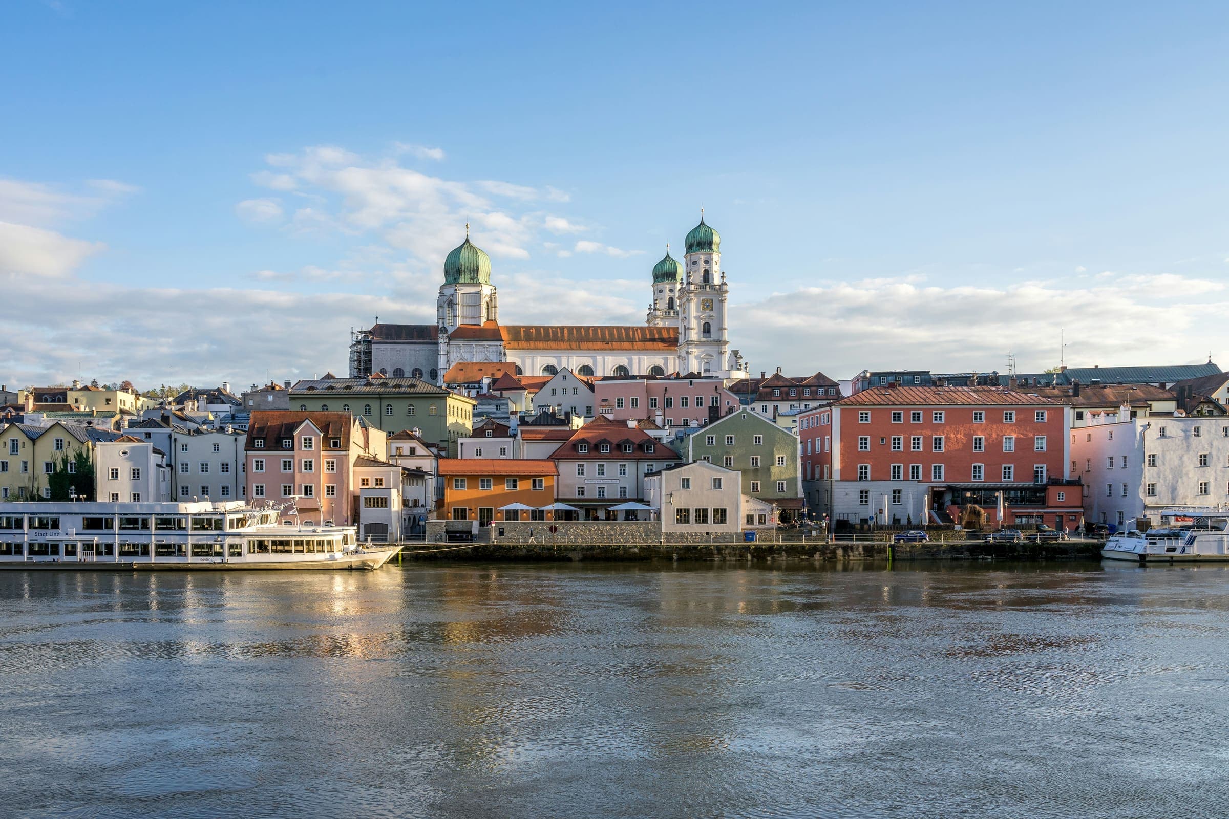 Passau from the water, its towers and pastel façades along the Danube