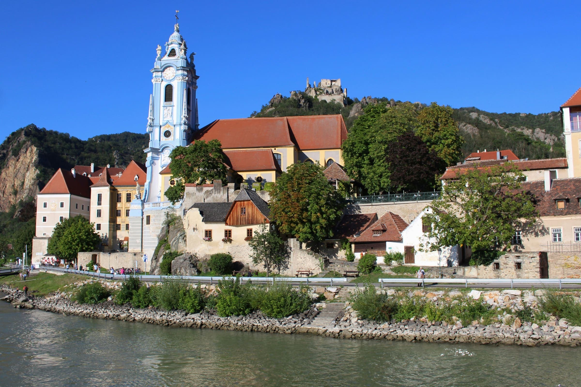 Dürnstein seen from the river, the blue church tower and the castle ruin on the hill above