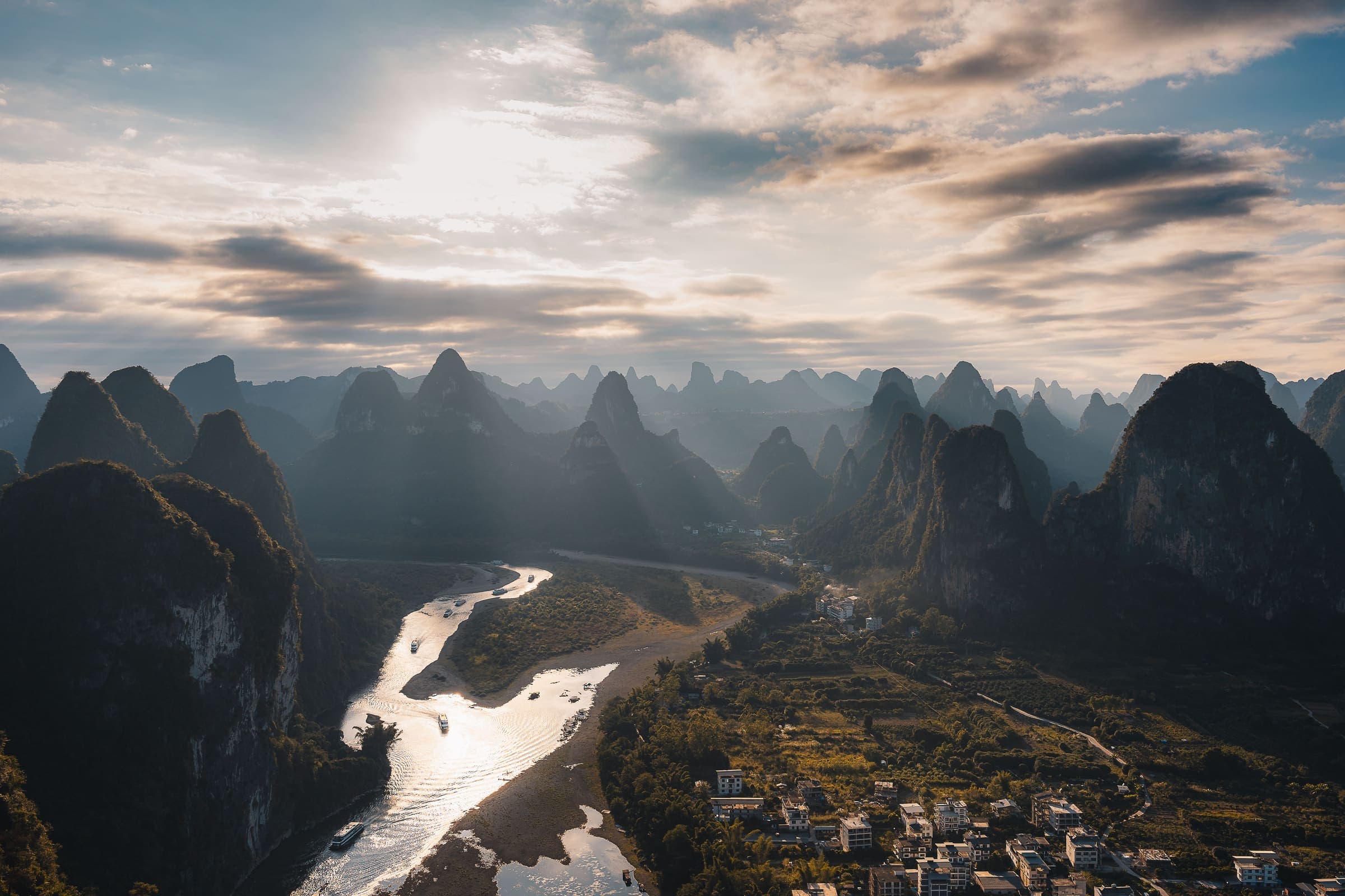 Karst peaks above a river bend at Guilin, mist lying along the valley floor