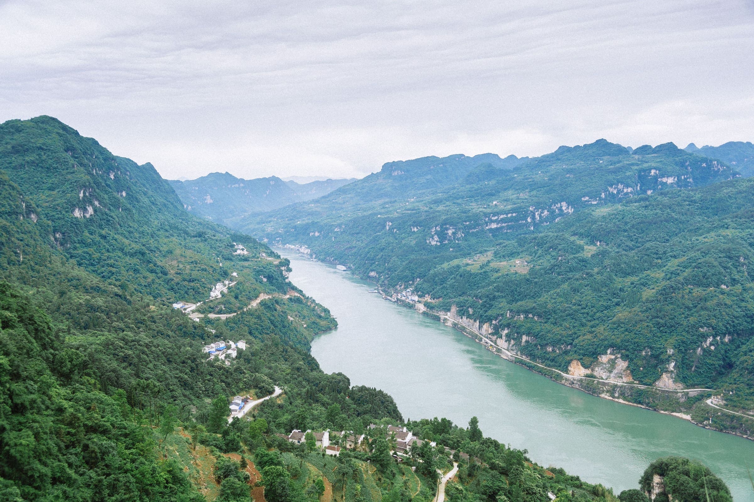 The Yangtze winding between forested ridges near Yichang, seen from high above